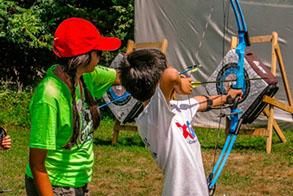 Boy shooting archery | summer camp jobs in New Jersey